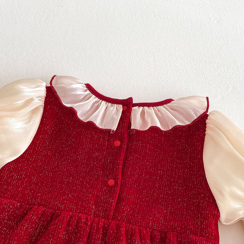 Back button closure on red knit baby romper