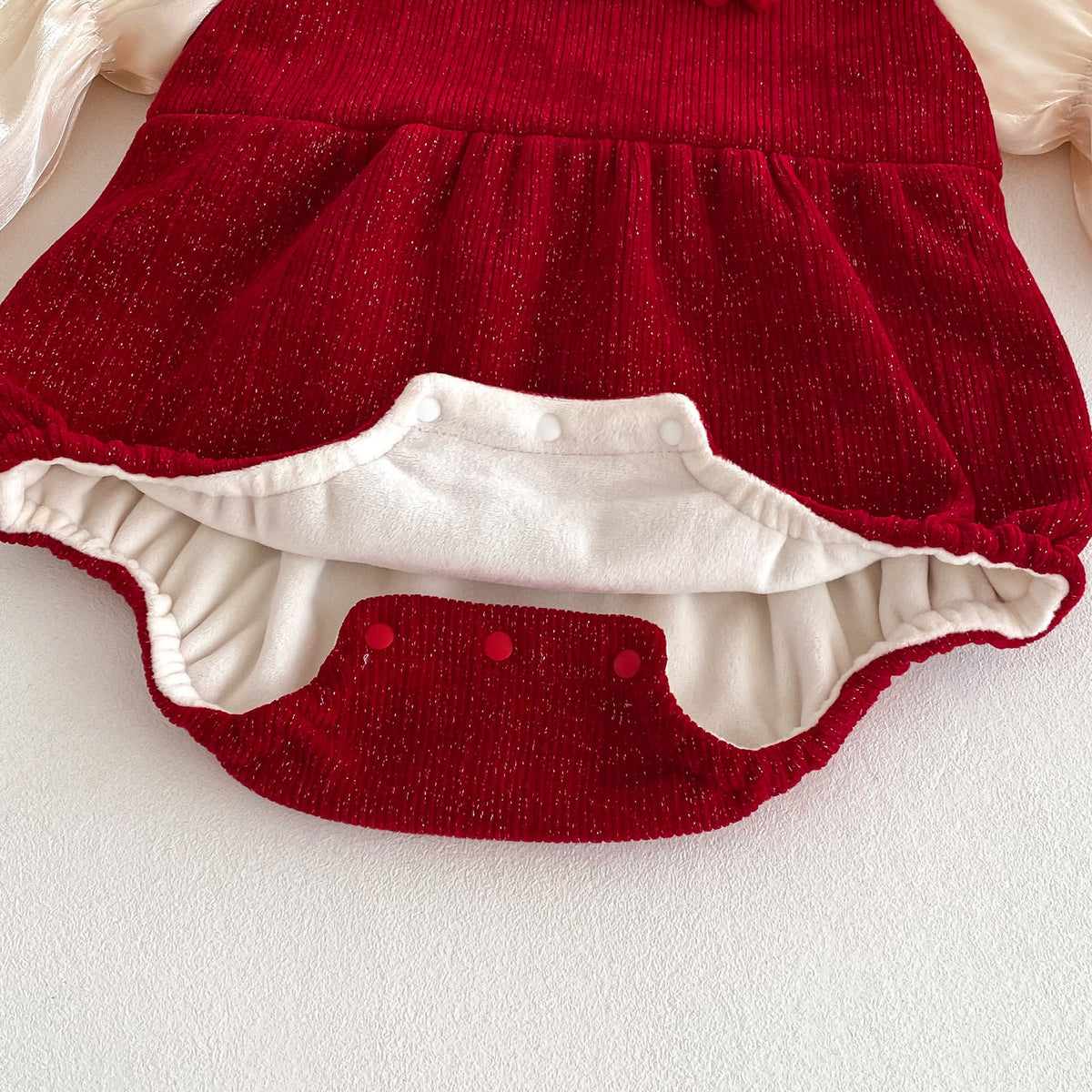 Snap closure and lining on red baby bubble romper