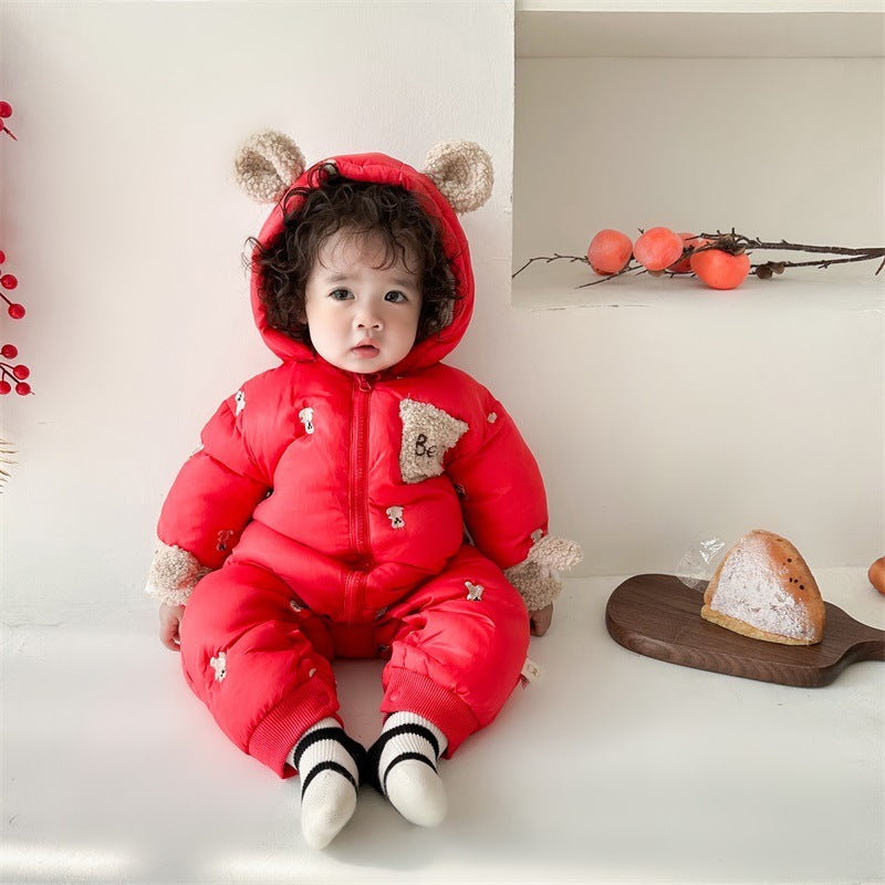 Baby in red bear ears snowsuit with hood up