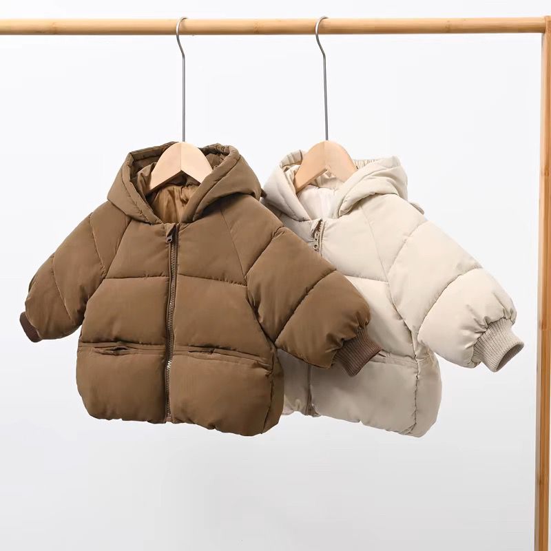 Brown and beige bear ears puffer jackets on a clothes rail