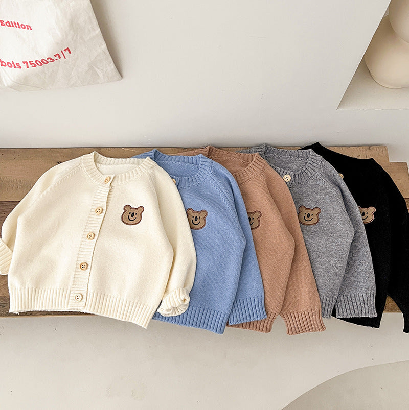 Row of bear patch knit cardigans