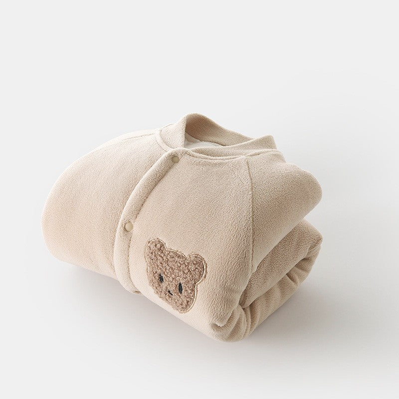 Folded fleece jumpsuit showing bear patch
