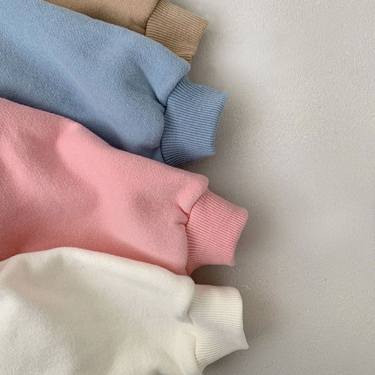 Close-up of cuffs on pastel bear sweatshirts