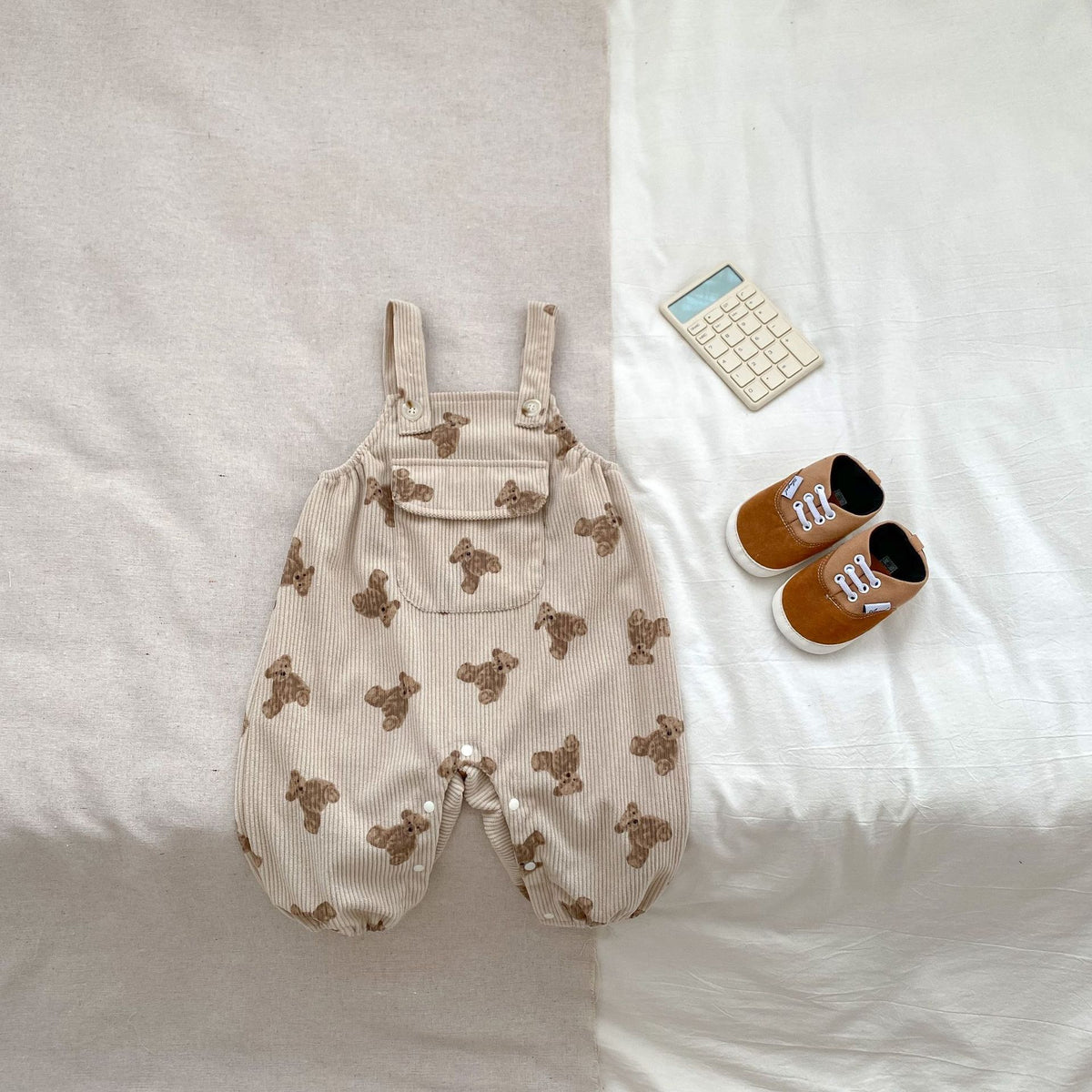 Beige sleeveless bear print baby romper with bib pocket
