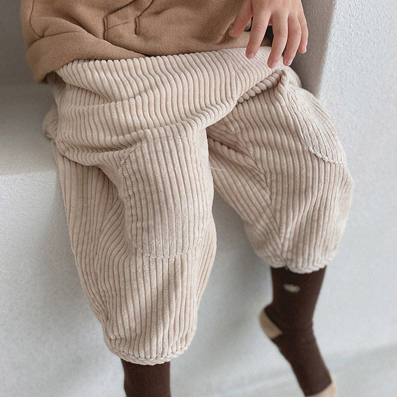Baby wearing beige corduroy carrot pants