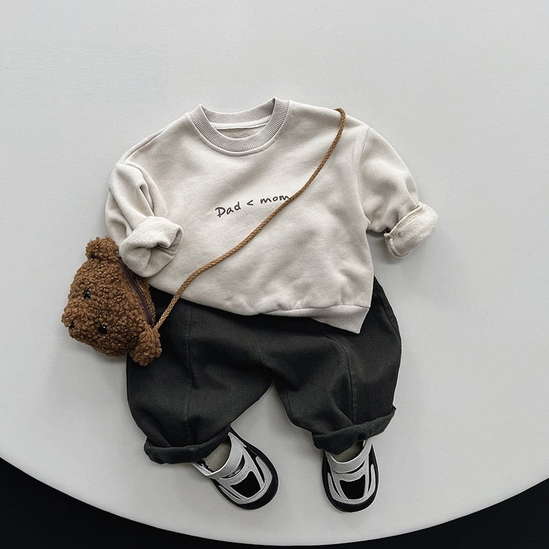 Beige Dad < Mom sweatshirt styled with black trousers and bag