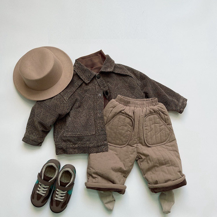 Beige quilted pants styled with brown jacket and hat