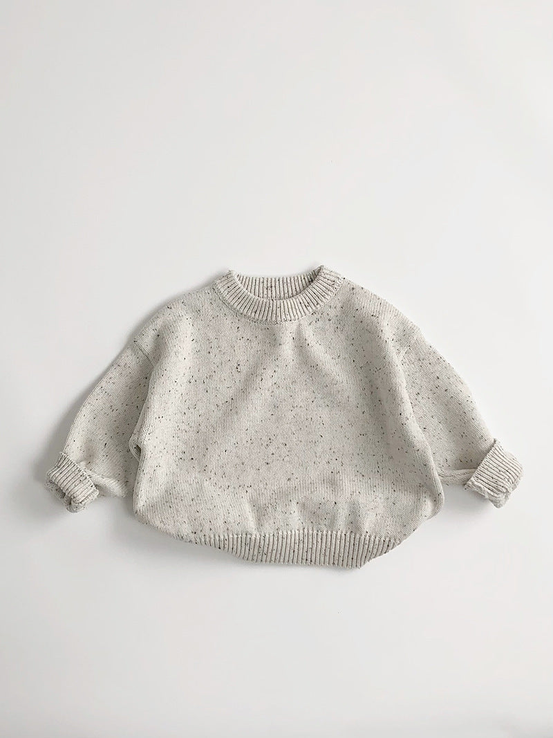 Beige speckled knit baby sweater on white background