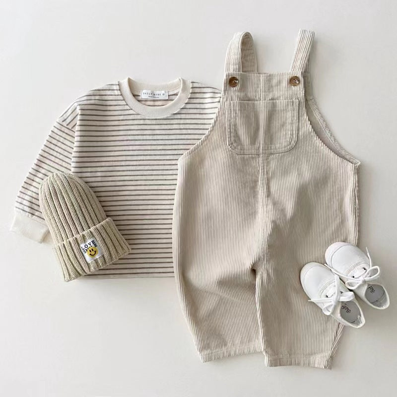 Beige waffle texture baby overalls styled with striped top, beanie and sneakers