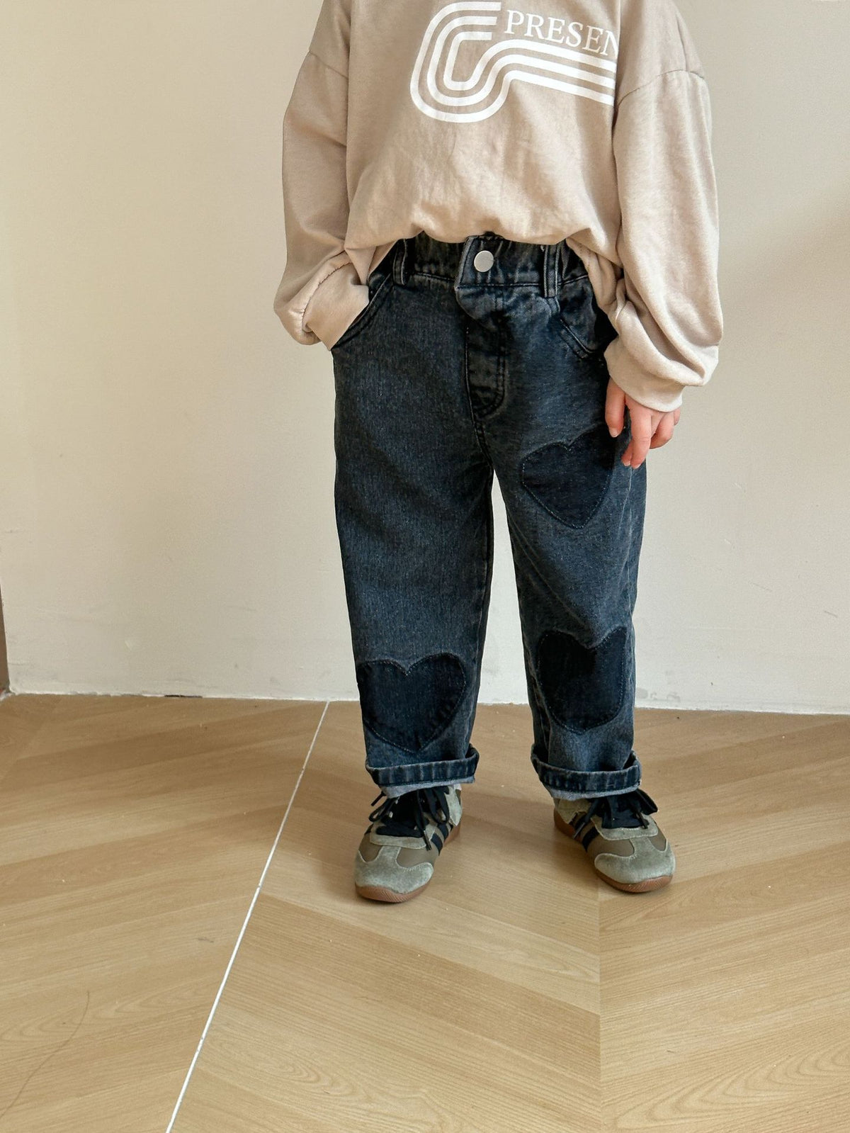 Child wearing black heart patch straight jeans
