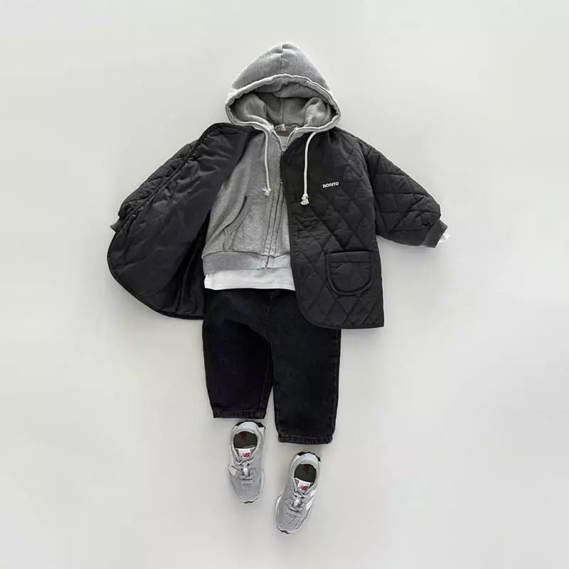 Black quilted jacket styled with gray hoodie and pants