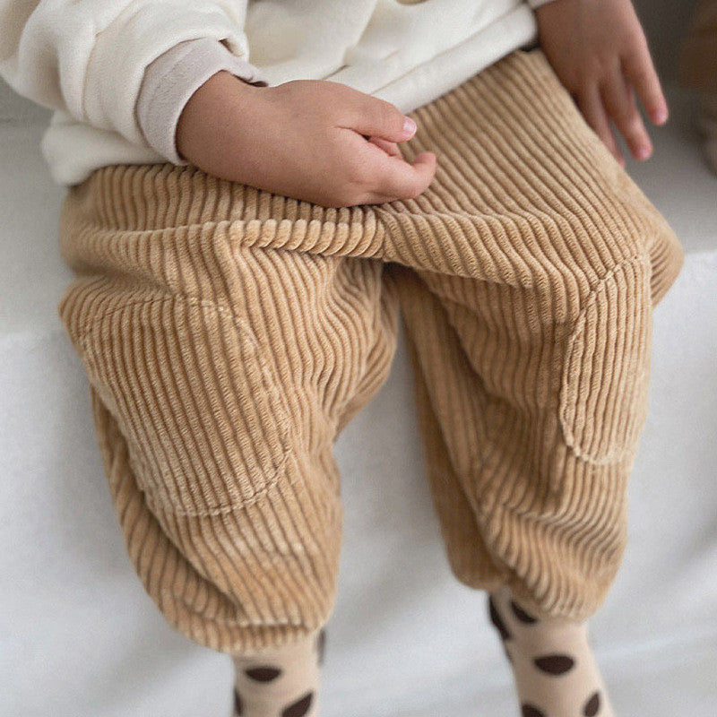 Baby wearing brown corduroy carrot pants