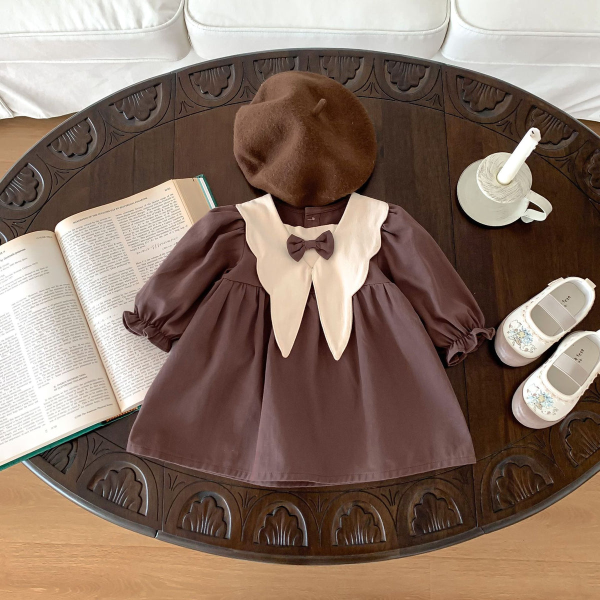 Brown corduroy dress with beret laid flat