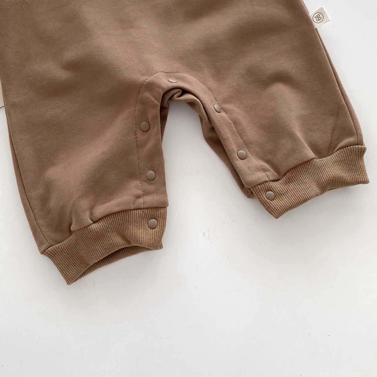 Close-up of ribbed ankles on brown jumpsuit