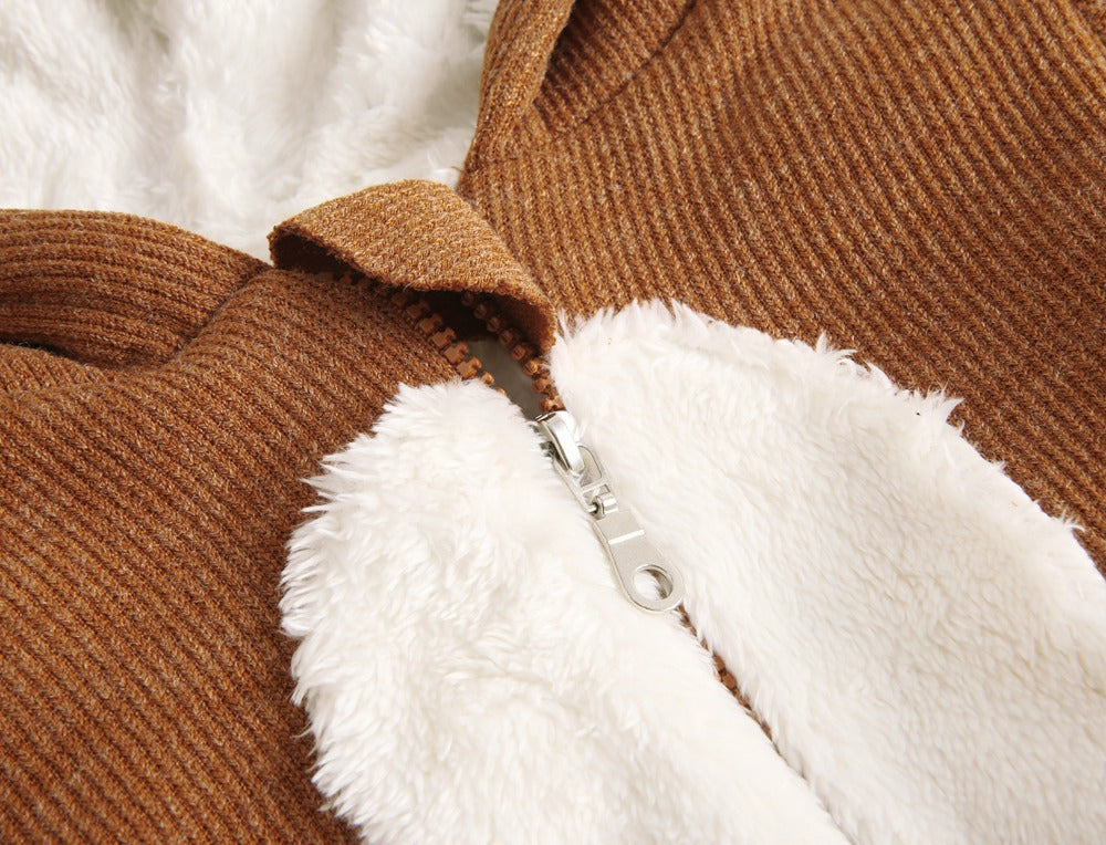 Close-up of fluffy sherpa tummy patch on brown jumpsuit