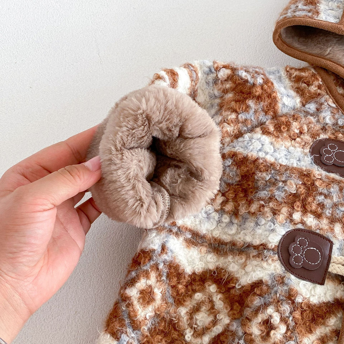 Close-up of the plush-lined cuff and woven fair isle texture