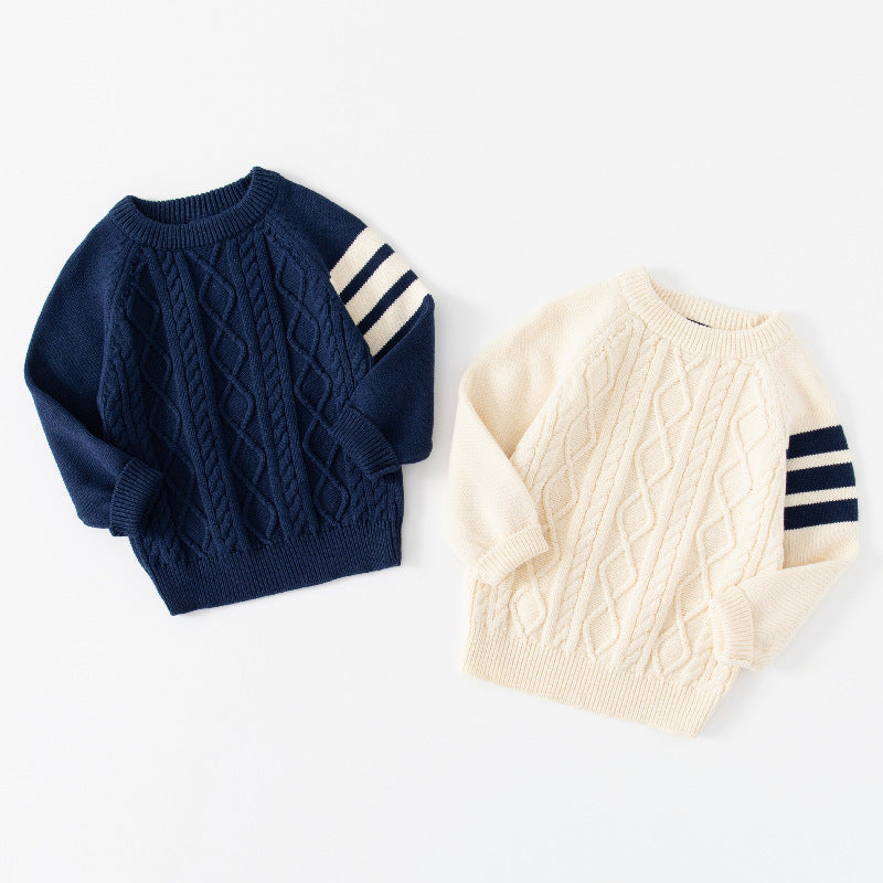 Navy and cream cable knit baby sweaters side by side