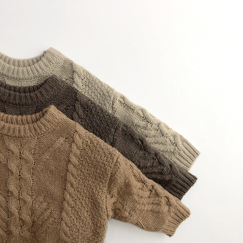 Stacked chunky cable knit sweaters in three colours