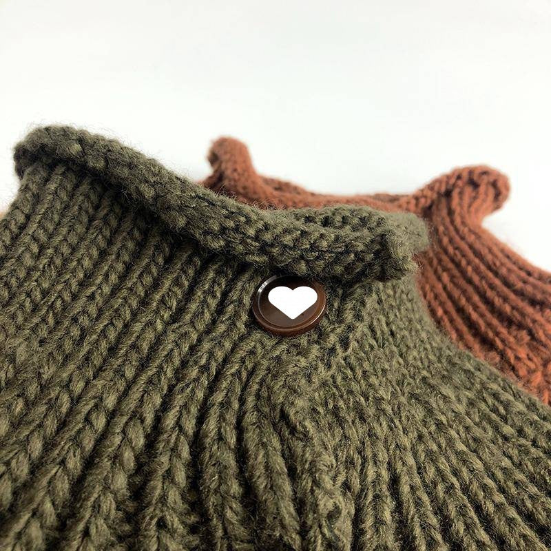 Close-up of chunky knit stand collar and heart button