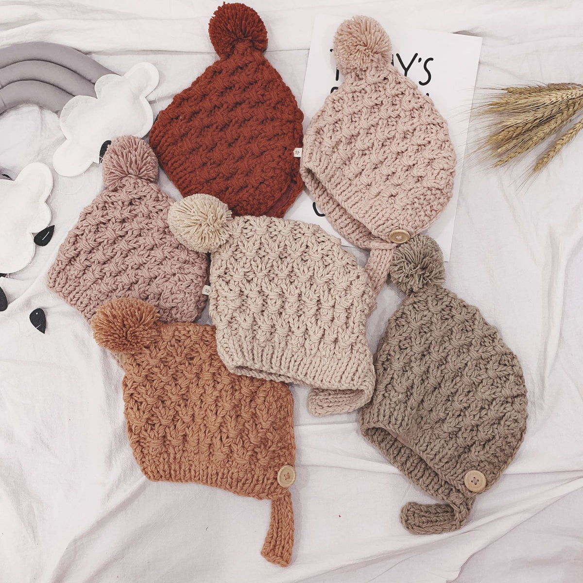 Chunky knit pom-pom baby bonnets in five colours