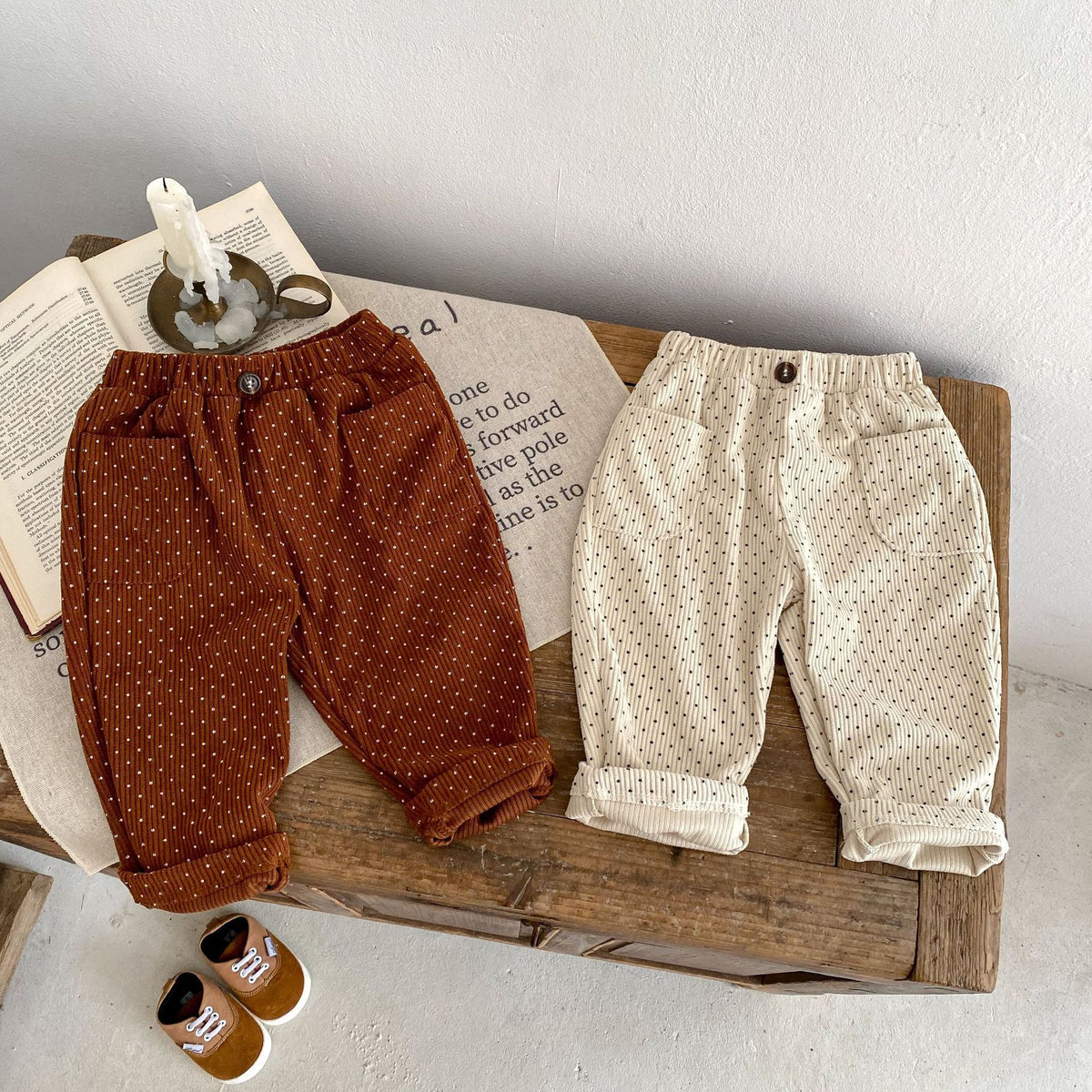 Dark brown and beige corduroy baby trousers on a table