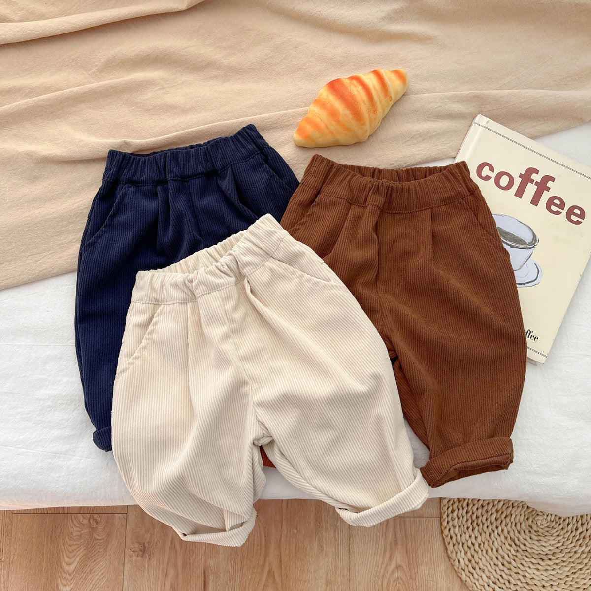 Three corduroy baby pants stacked