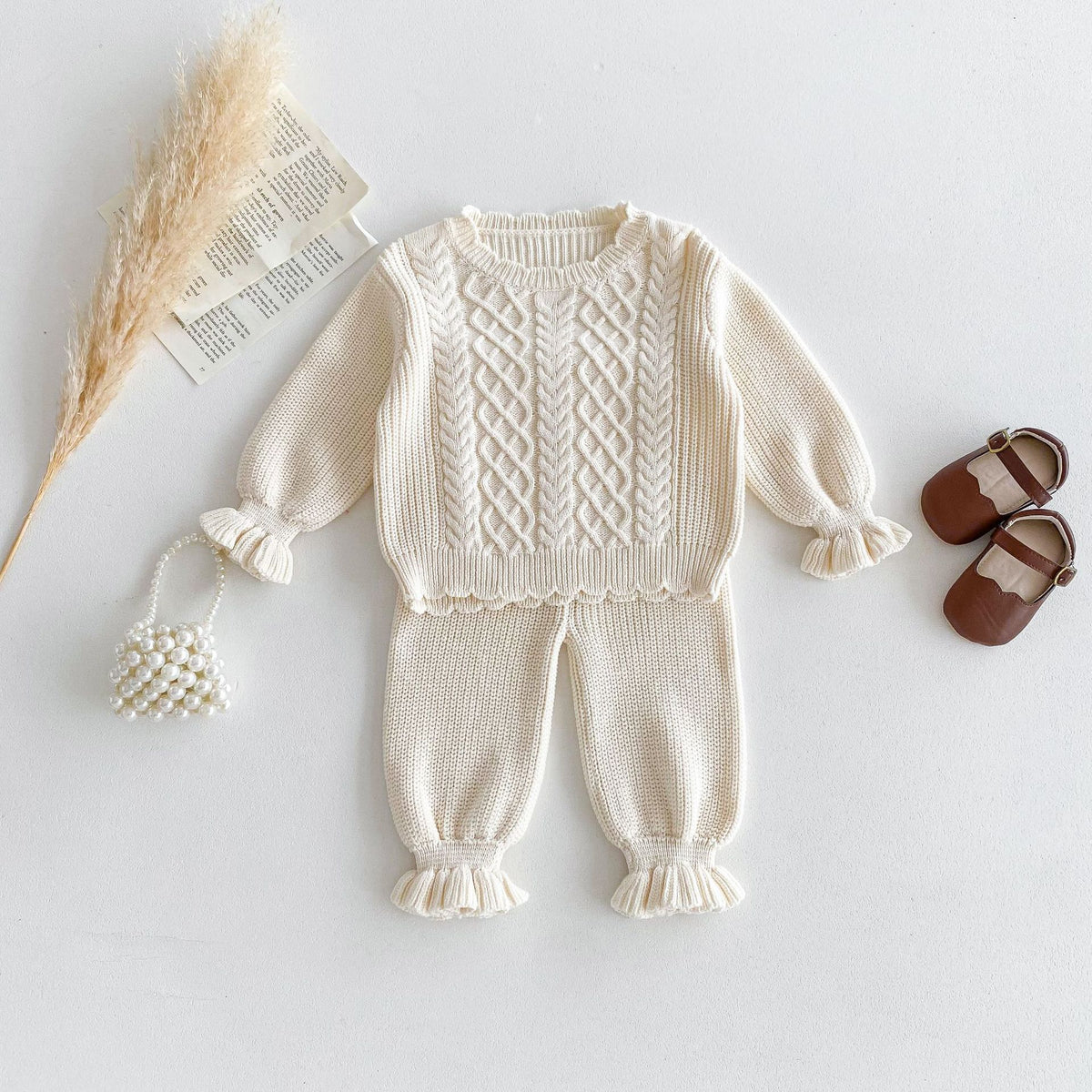 Cream cable knit sweater with ruffle cuffs and matching ruffle hem pants