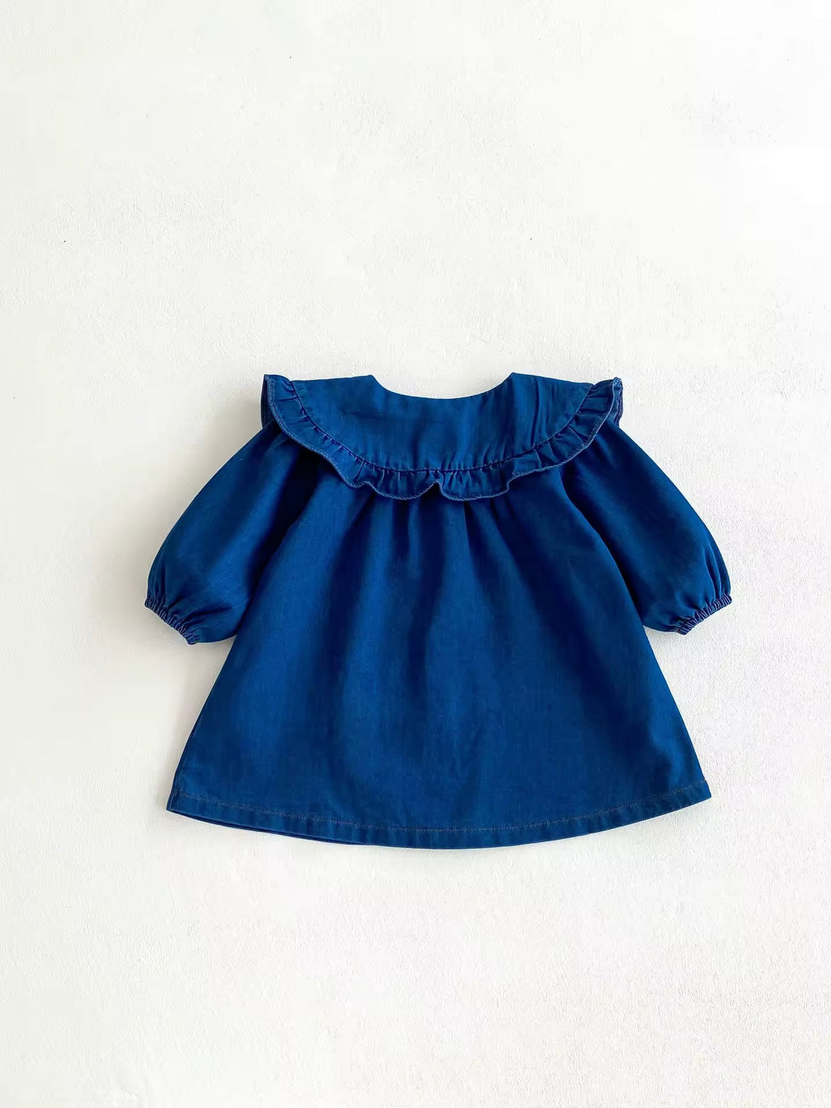 Back view of blue denim ruffle collar baby dress