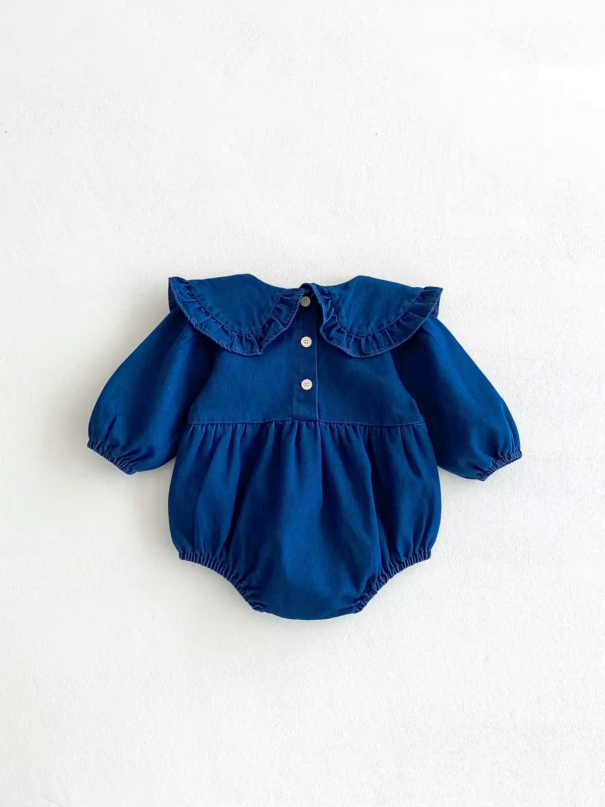 Back view of blue denim baby romper