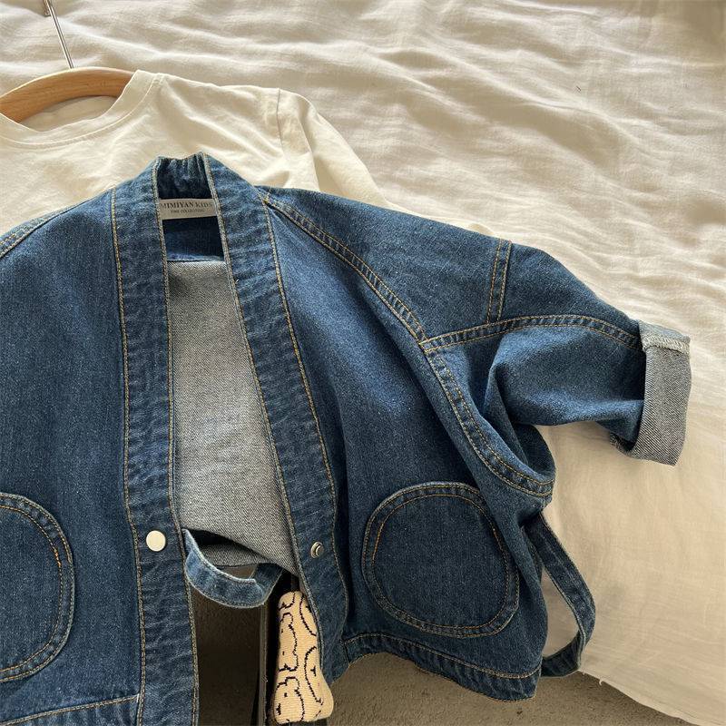 Denim wrap jacket opened on a hanger