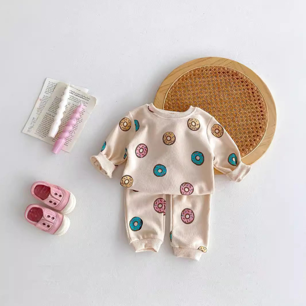 Donut print baby pajama set laid flat with slippers
