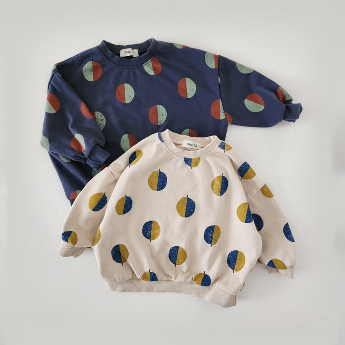 Navy and beige dot print pajama tops on white background