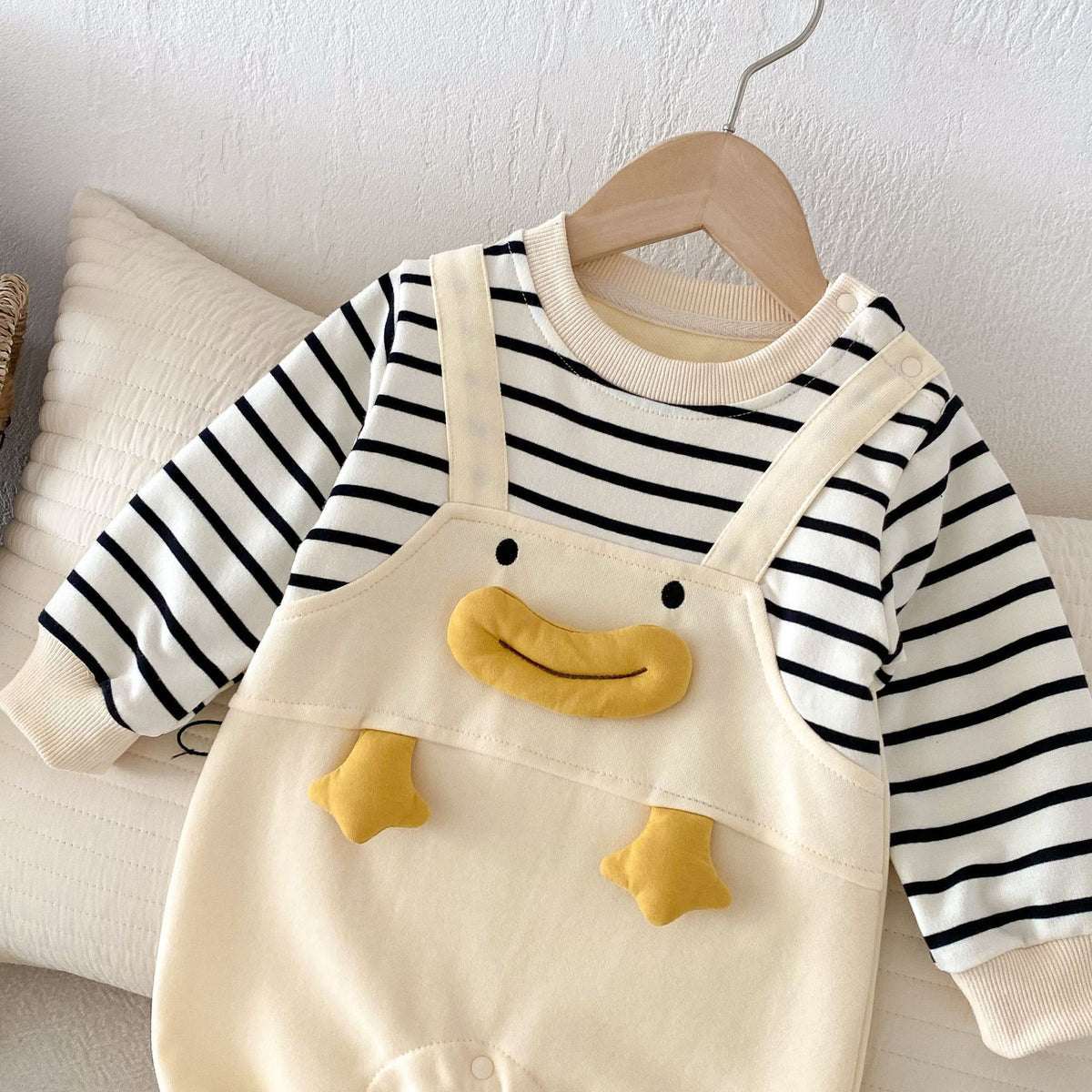 Duck mock overall baby romper on a hanger
