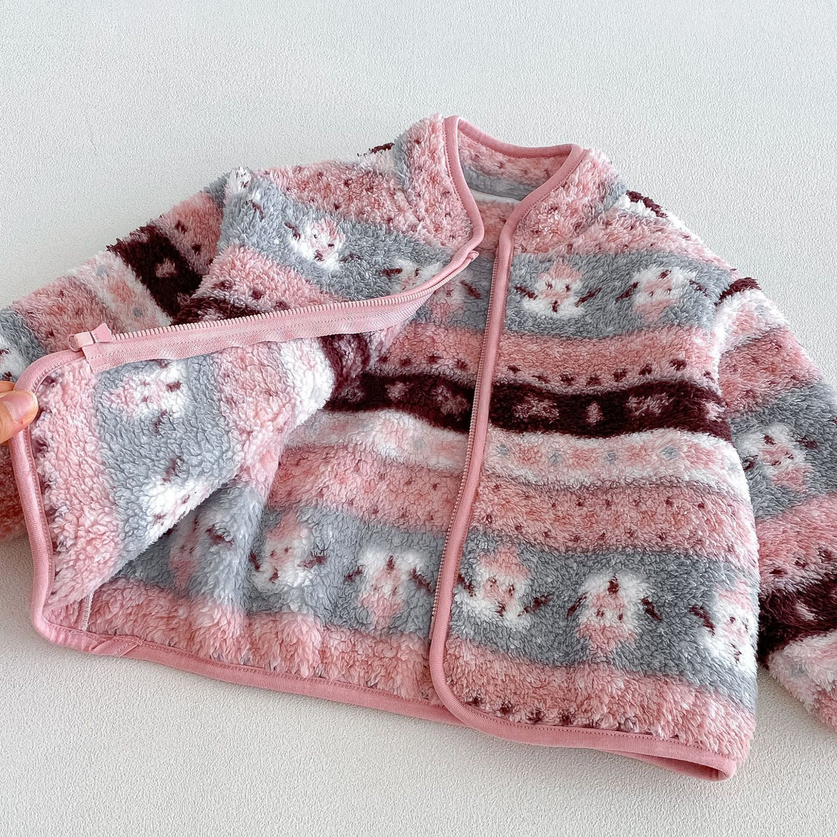 Open rose fleece jacket showing the piped zip front