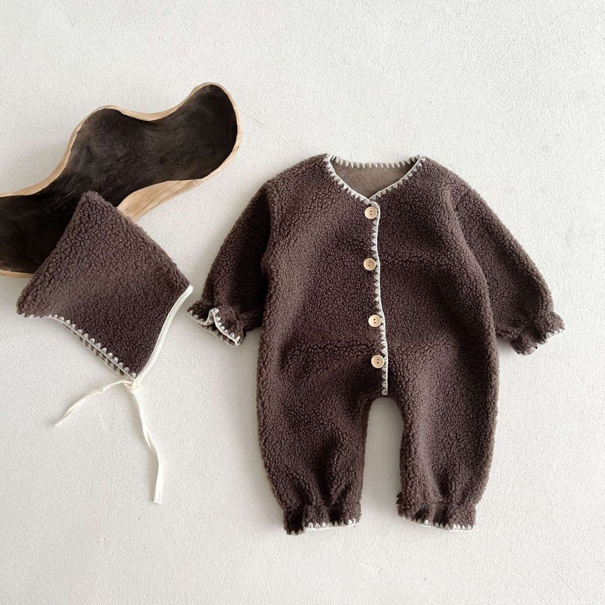 Cocoa brown sherpa baby romper with wooden buttons, flat lay