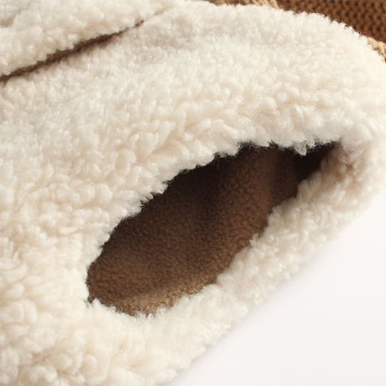 Armhole detail of the cream sherpa vest with fleece lining