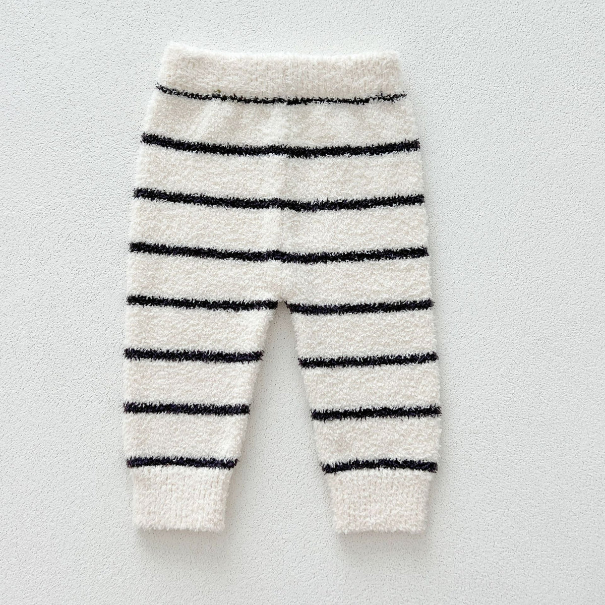Cream knit pants with black stripes and ribbed cuffs