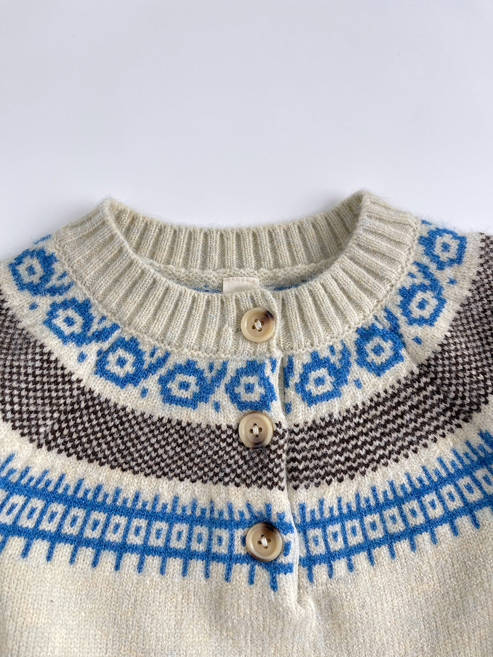 Close-up of Fair Isle yoke and wooden buttons