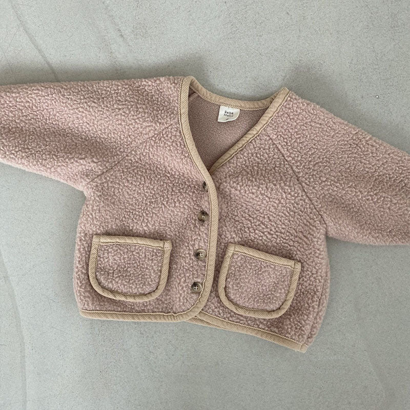 Close-up of polar fleece cardigan pockets and buttons