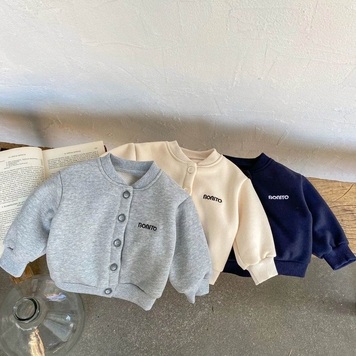 Three fleece-lined baby jackets laid flat