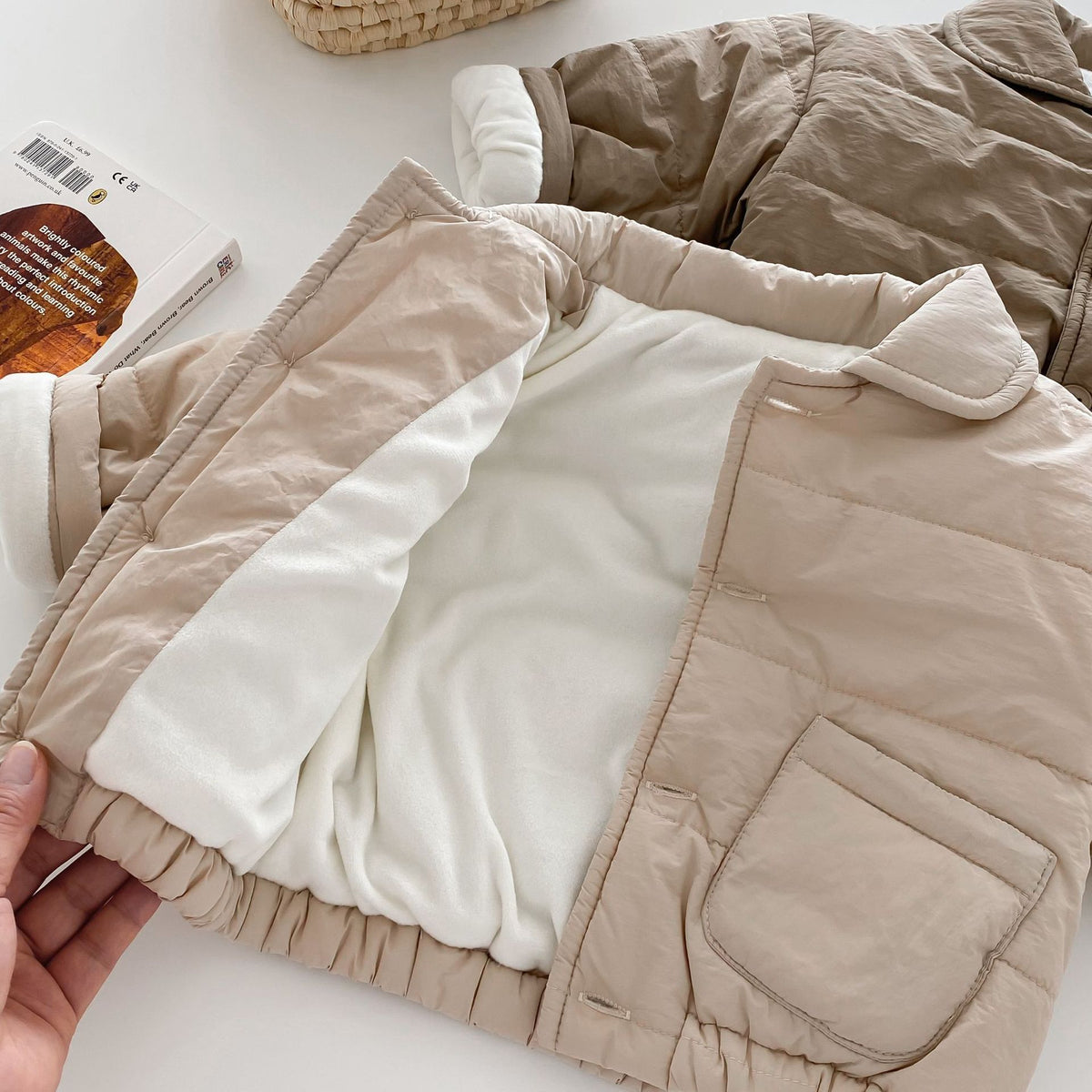 Padded baby coat opened to show plush fleece lining