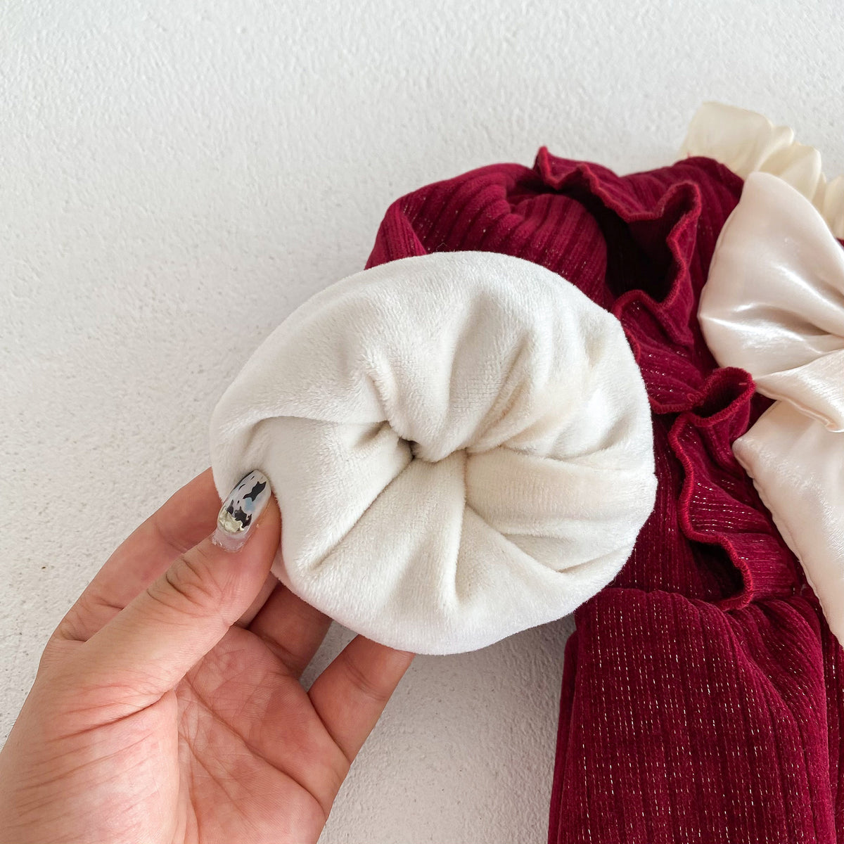 Hand showing fleece lining inside red romper sleeve