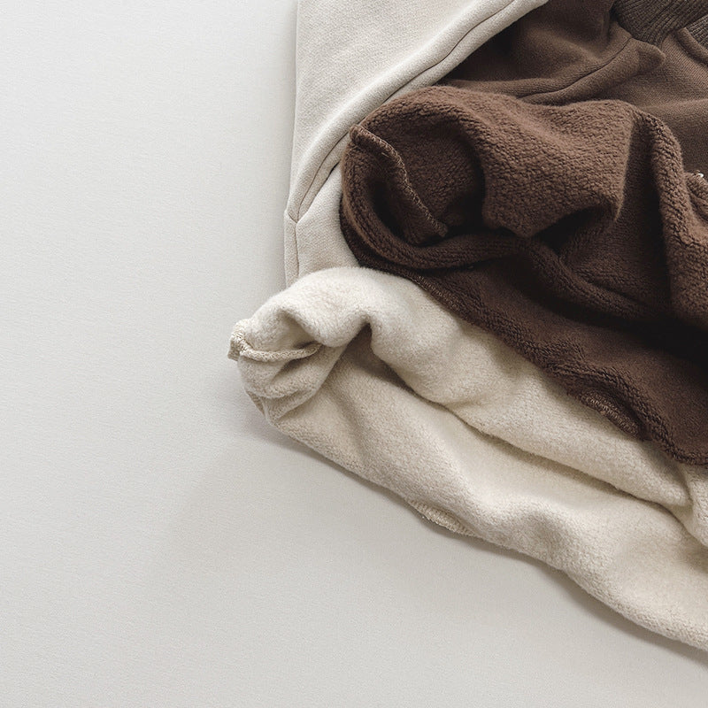 Close-up of soft fleece lining inside beige and brown sweatshirts