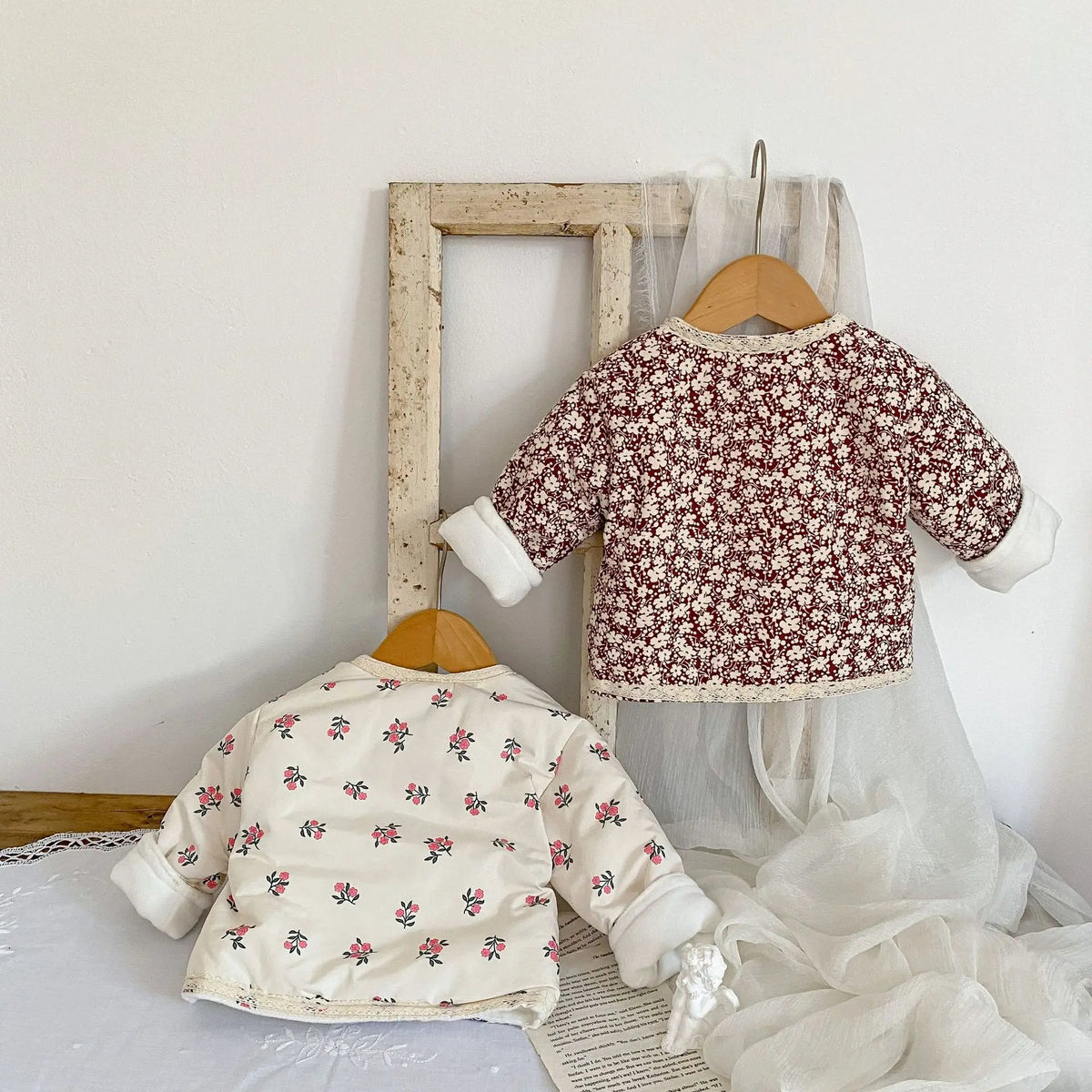 Floral jackets hanging by a mirror