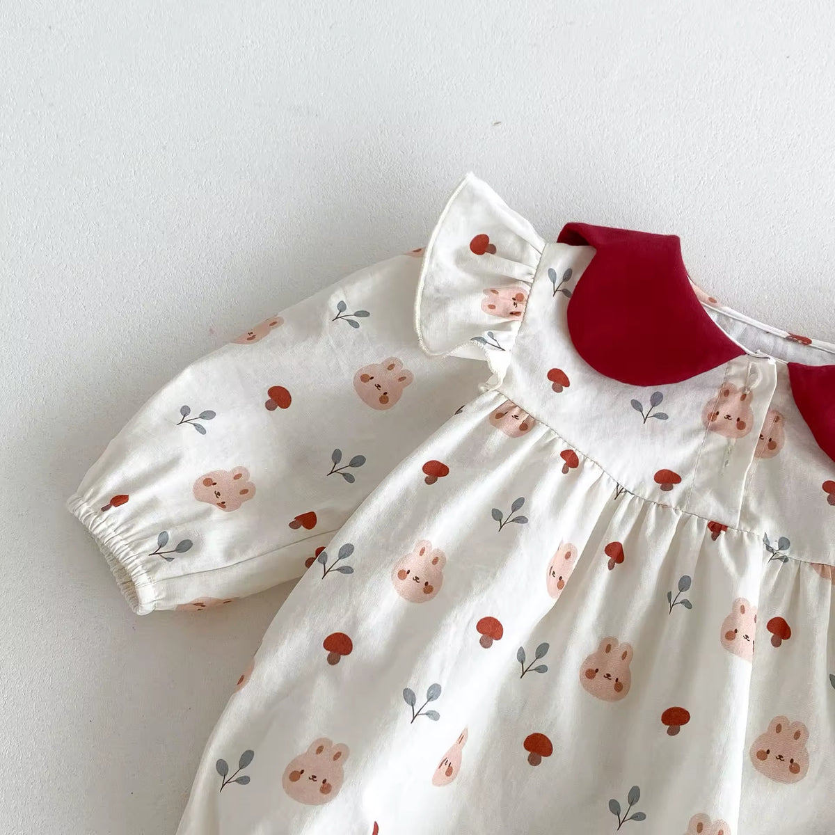 Close-up of puff sleeve on floral baby romper