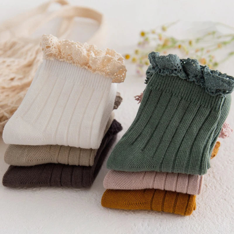 Stack of ribbed frill top socks in neutral colours
