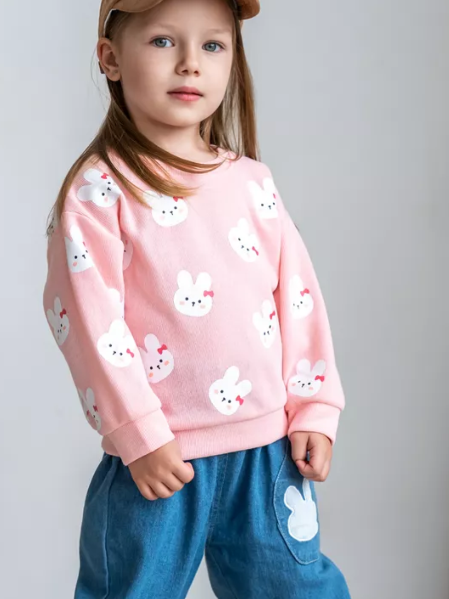 Girl wearing pink bunny print top and jeans