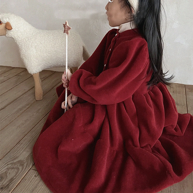 Girl wearing red fleece princess dress holding a wand