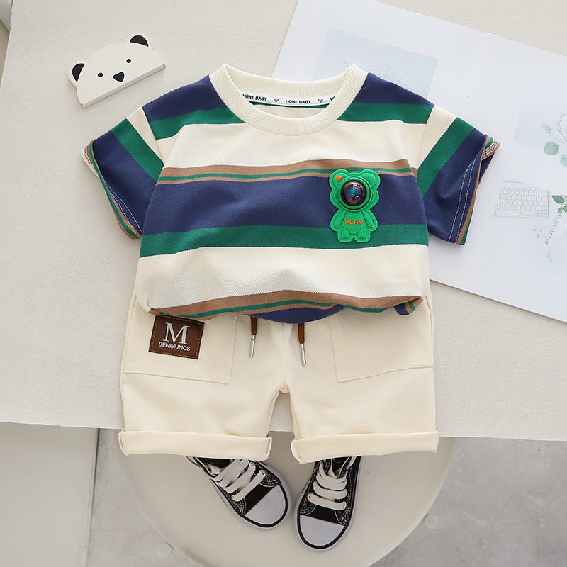 Green and navy striped tee with bear patch and cream shorts