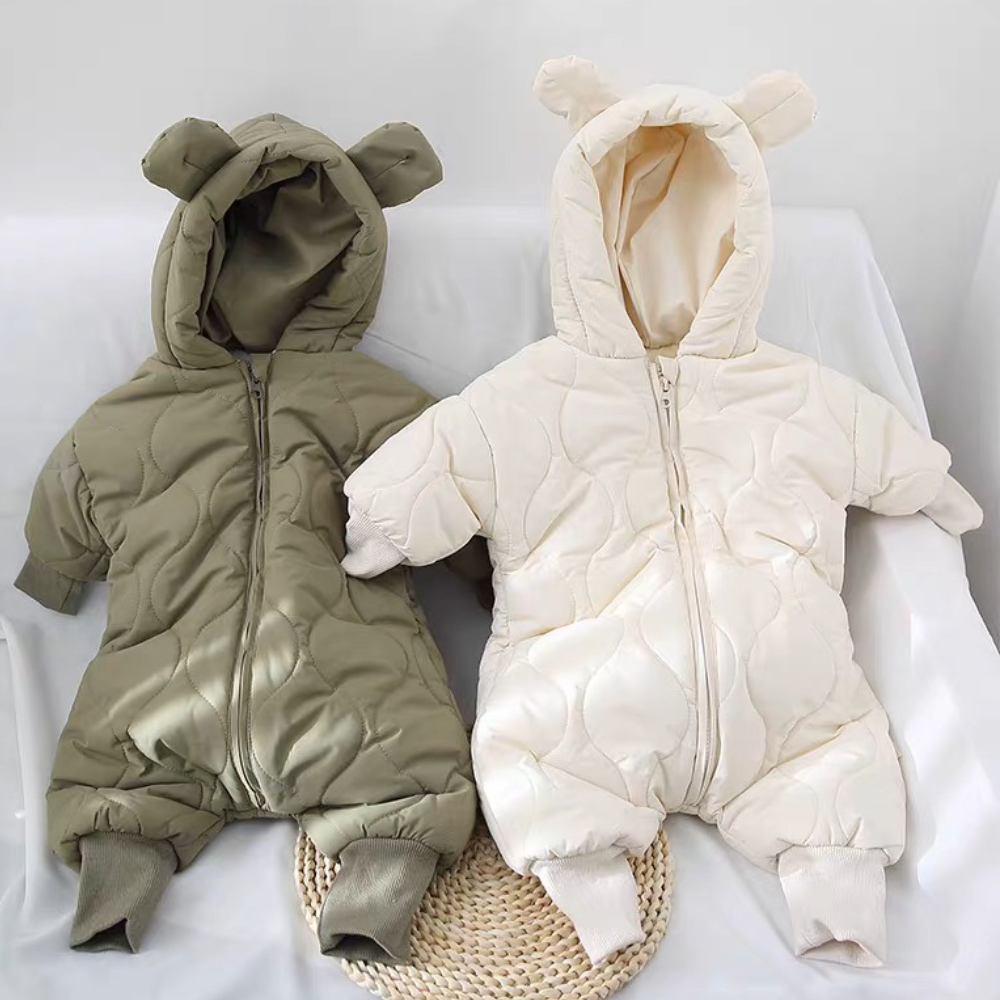 Green and white bear ear baby snowsuits laid flat
